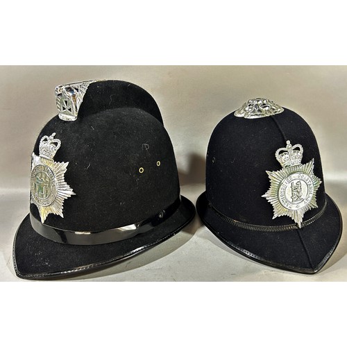 661 - A Warwickshire Constabulary Policeman’s helmet and another Northumbria Police helmet.