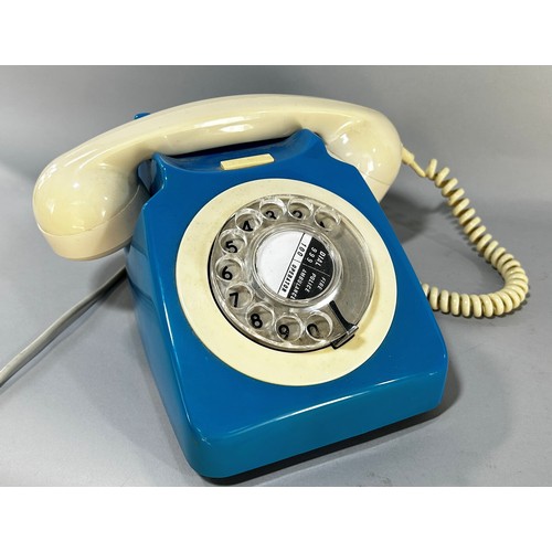 676 - A blue retro rotary telephone with a cream hand set, together with a railway cigarette card album an... 