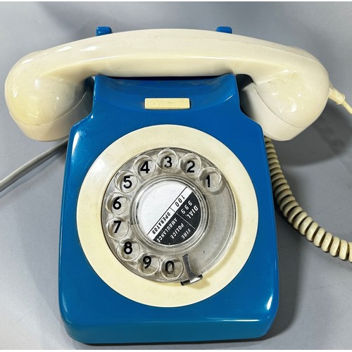 676 - A blue retro rotary telephone with a cream hand set, together with a railway cigarette card album an... 