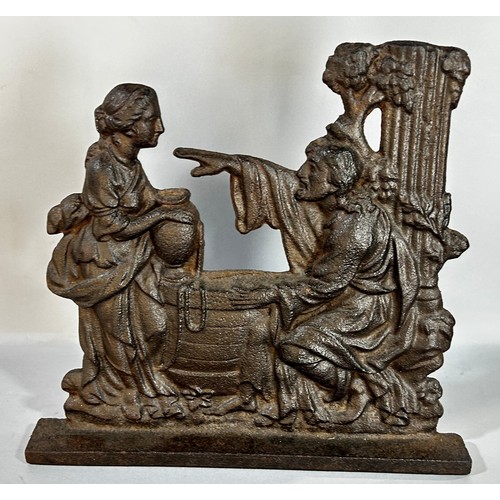 677 - A 19th century cast iron door stop depicting Jesus and the Samaritan Woman at a well, 29cm wide x 27... 