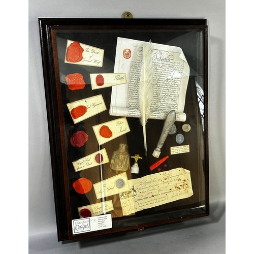 693 - A Collage of writing equipment, parchment and quill, wax seals etc in glazed framed display case, 57... 