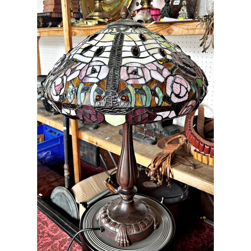 691 - A Tiffany style table lamp with a floral leaded shade 60cm high.