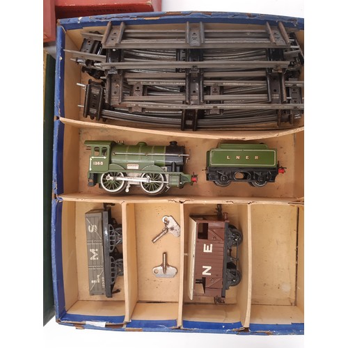 892 - A collection of Hornby 0 gauge railway models including 3 clockwork locomotive train sets, boxed Hor... 