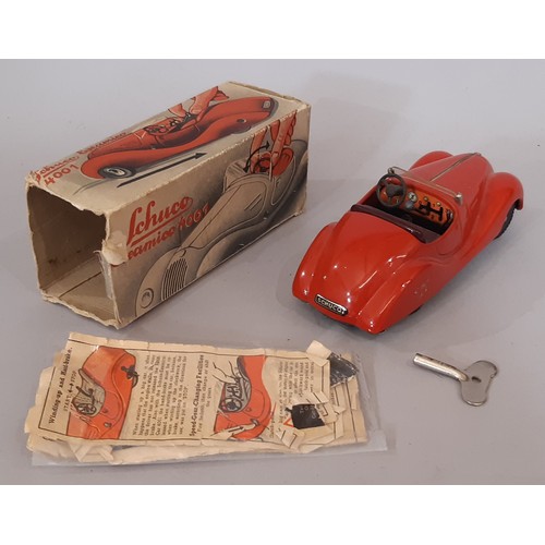 895 - Two clockwork cars by Schuco comprising vintage Examico 4001 with instructions, and Akustico 2002 (r... 