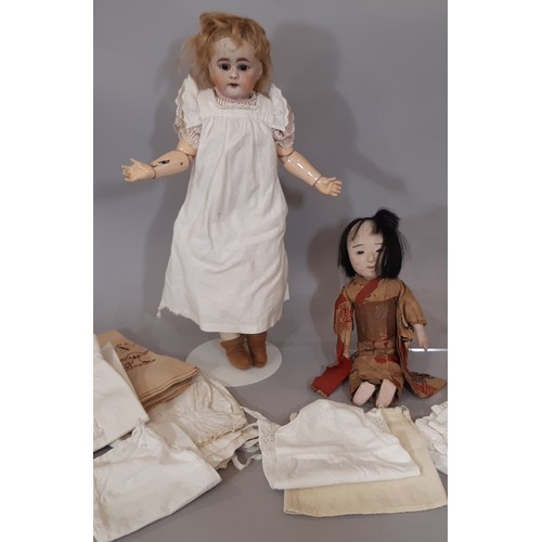 896 - Two early 20th century dolls comprising a bisque head shoulder head doll with jointed kid body, comp... 