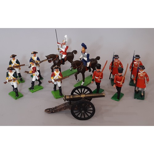 903 - A large collection of painted cast metal model soldiers, guards and cavalry including Yeoman Guards ... 