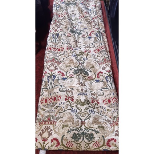 910 - A pair of good quality extra long curtains in a heavy woven brocade type fabric of heraldic and clas... 