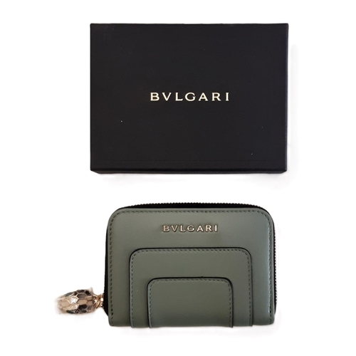 32 - Mini zipped wallet by Bulgari in green sage leather with serpent key pull feature. 11x8cm. Boxed and... 