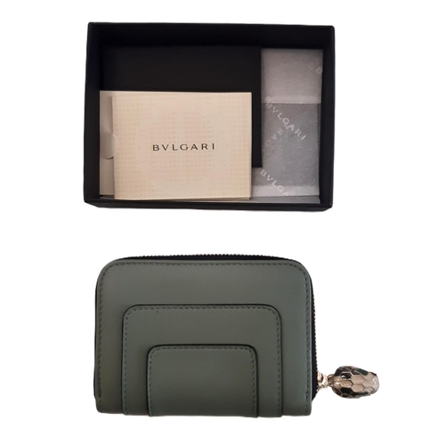 32 - Mini zipped wallet by Bulgari in green sage leather with serpent key pull feature. 11x8cm. Boxed and... 