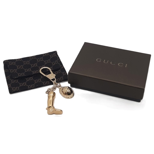 35 - Gucci  keyring featuring a riding boot and hat in gold metalwork with monogrammed cloth bag and box.... 