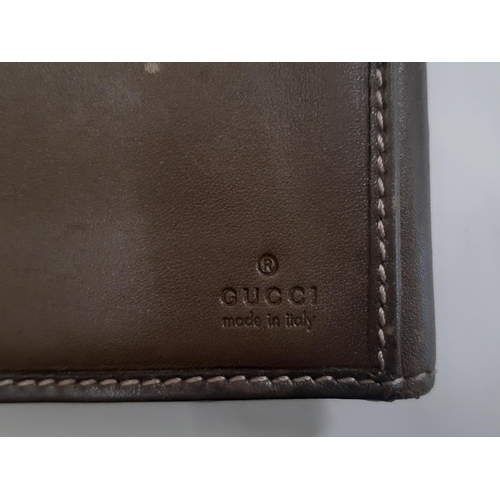 36 - Gucci  wallet purse in leather and suede with gold monogrammed hardware to front. Used. 19x11cm