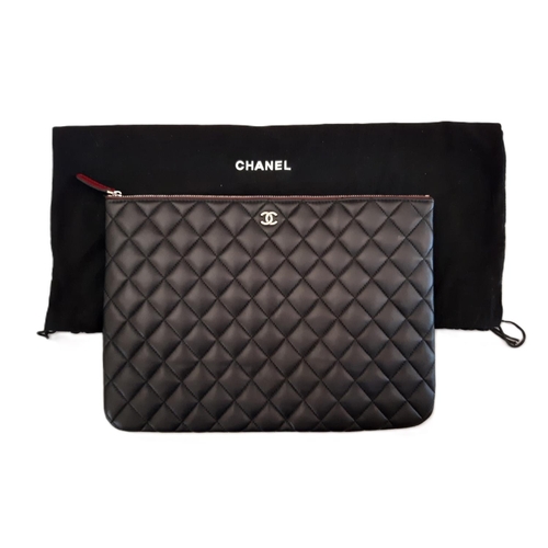 38 - Zipped case marked 'Chanel' in quilted black leather 34x24cm with cloth bag