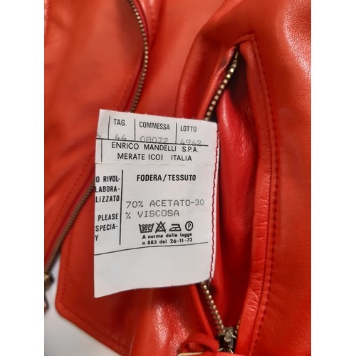 61 - Red leather women's jacket by Moschino with embroidered  writing verso, size 12