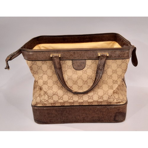 76 - Vintage vanity / travel bag by Gucci in monogrammed canvas and leather with top handles and zip clos... 