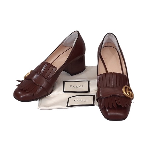 92 - A pair of Gucci Marmont pumps/ shoes in brown leather with fringe detail, GG hardware logo and cloth... 