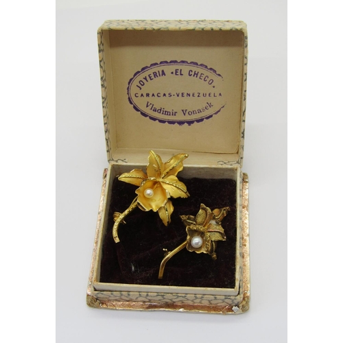 406 - Two vintage Venezuelan orchid brooches, each stamped '18k', 9.4g total, with a Venezuelan box