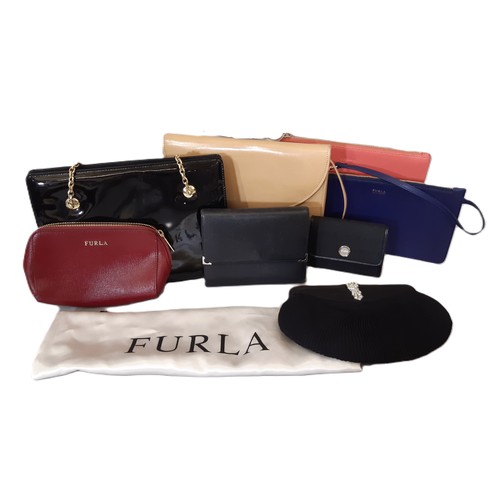 108 - A collection of small bags and leather goods including a wallet by Cartier, three zipped purses by F... 