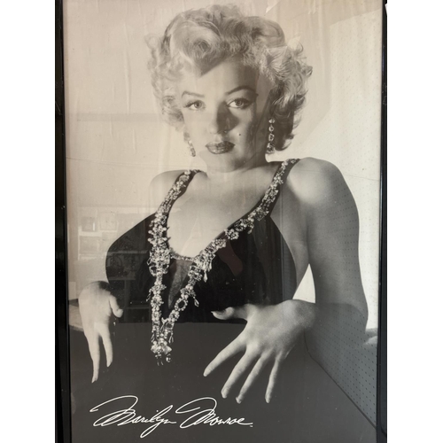 1841 - Two large black and white photographs of Marilyn Monroe, 66 x 97 cm, both framed and glazed (crack t... 