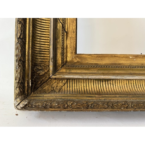 1948 - A 19th century gilt gesso frame with laurel leaf decoration, interior dimensions: 61 x 41 cm, frame ... 