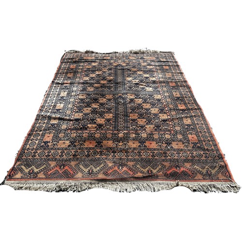 1655 - A Turkey carpet with an all over geometric pattern on an orange ground 240cm x 170cm approximately