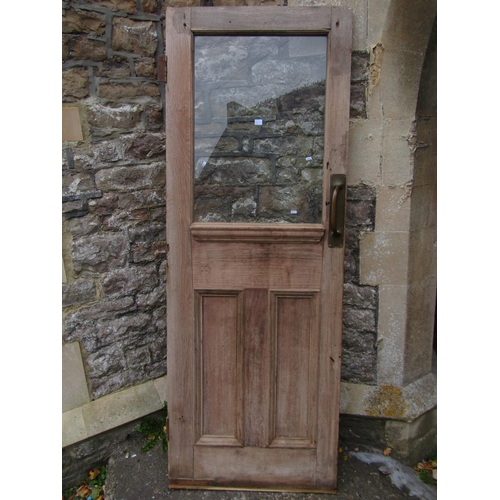 1075 - An reclaimed stripped and weathered hardwood partially glazed panelled door, 208cm high x 76cm wide