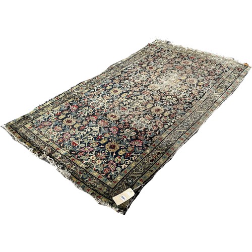 1659 - An old Persian rug with an all over floral pattern 200cm x 120 approximately.