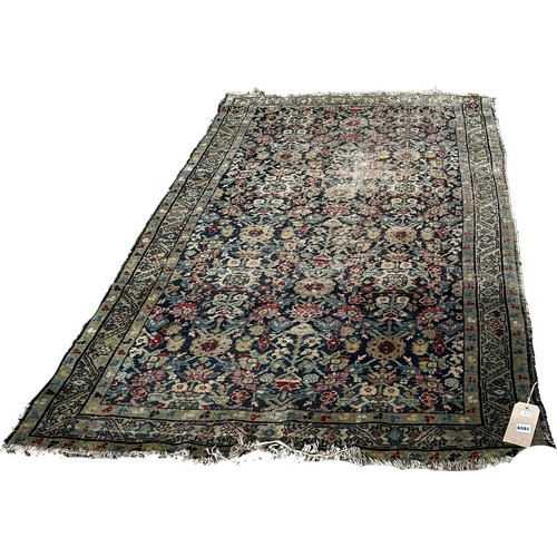 1659 - An old Persian rug with an all over floral pattern 200cm x 120 approximately.