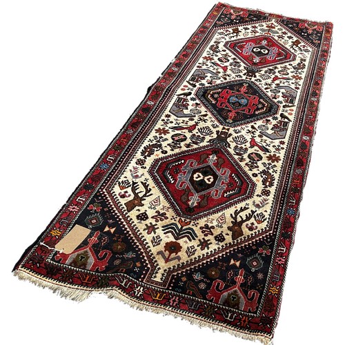 1662 - A Qashqai corridor carpet with a central row of medallions on a cream ground 255cm x 81cm approximat... 