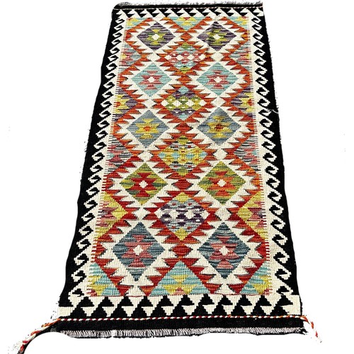 1663 - A Chobi Kilim runner with alternating row of stepped diamonds, 158cm x 72cm approximately