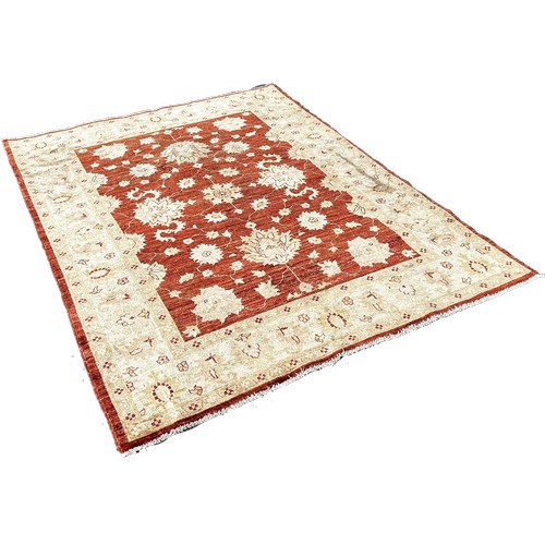 1666 - A Ziegler design carpet with an all over floral pattern with a central red panel, 210cm 150cm approx... 