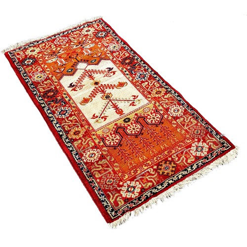 1668 - Three small Persian rugs, a brightly coloured rug with a central cream panel, brown rug with an all ... 