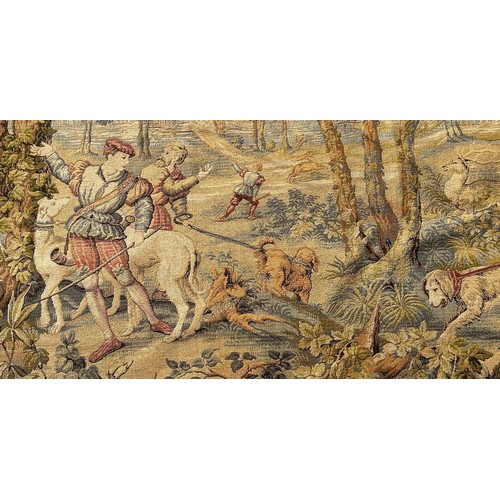 1669 - A large Belgian style tapestry wall hanging, huntsmen and their dogs with a stag amongst woodland, w... 