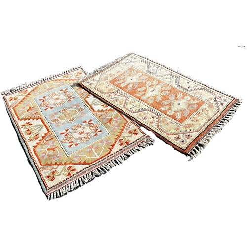 1676 - Two small Kazak style carpets in matching pastel tones peach and orange, 120cm x 80cm