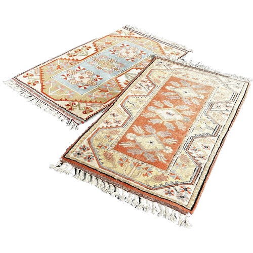 1676 - Two small Kazak style carpets in matching pastel tones peach and orange, 120cm x 80cm