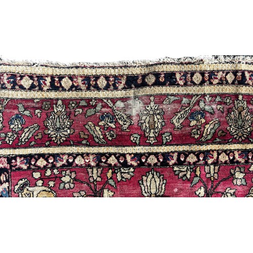 1673 - A fine old Persian carpet with a central vase of flowers set in a prayer arch with further floral de... 