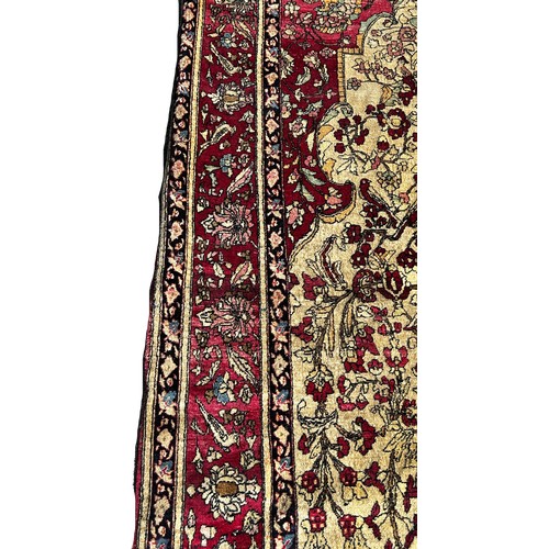 1673 - A fine old Persian carpet with a central vase of flowers set in a prayer arch with further floral de... 