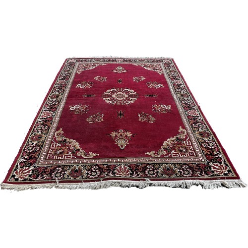 1694 - An Axminster type Middle Eastern style carpet with an all over floral pattern and one other machine ... 