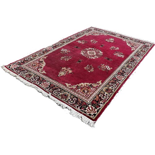 1694 - An Axminster type Middle Eastern style carpet with an all over floral pattern and one other machine ... 