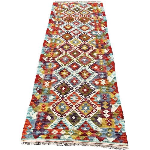 1698 - A Chobi Kilim runner with an all over multicoloured diamond pattern 248cm  x 82cm approximately