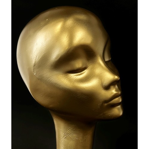 585 - An Art Deco Golden shop head and shoulder mannequin, with an imaginative elegant long neck, 62cm hig... 