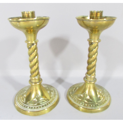 665 - A pair of Victorian brass candlesticks with spiral stem and splayed circular base, 19cm high.