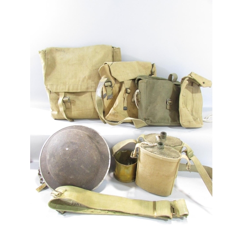 580 - A collection of WWII Equipment, including a ruck sack, webbing, helmet, water bottles, a field radio... 