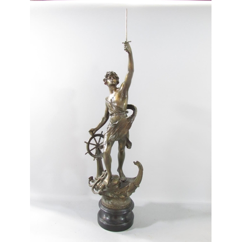 582 - A spelter figure of a victorious sailor, sword in hand, standing on elements of a ship raised on a s... 