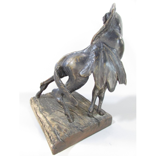 592 - A Bronzed sculpture “The Spirit Of Africa “ Gryphon, raised on a wooden base, bearing a label Sculpt... 