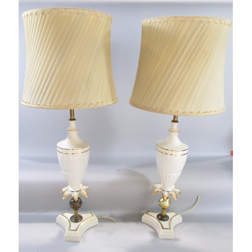 597 - A pair of white and gilt vase shaped table lamps and a pair of pleated shades.