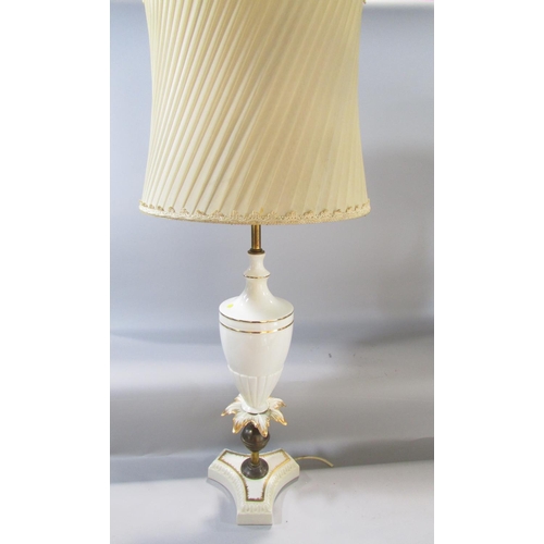 597 - A pair of white and gilt vase shaped table lamps and a pair of pleated shades.