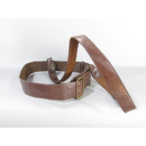 609 - A British Army issue brown leather Sam Brown belt and shoulder strap together with a khaki canvas pi... 