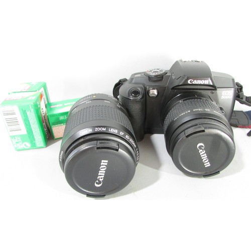 611 - A Canon EOS 5000 camera, an Olympus Zoom camera, a further lens and other photographic equipment hou... 