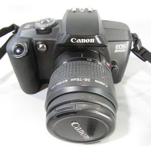 611 - A Canon EOS 5000 camera, an Olympus Zoom camera, a further lens and other photographic equipment hou... 