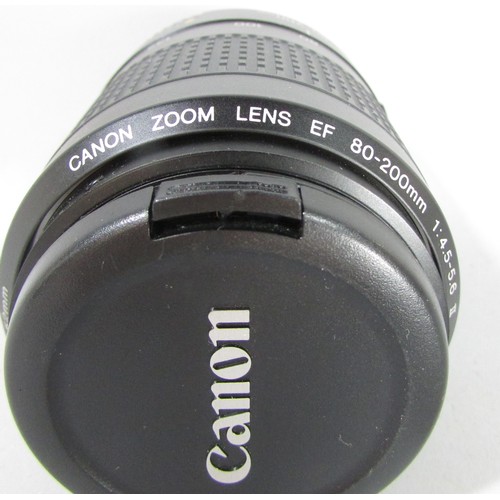 611 - A Canon EOS 5000 camera, an Olympus Zoom camera, a further lens and other photographic equipment hou... 